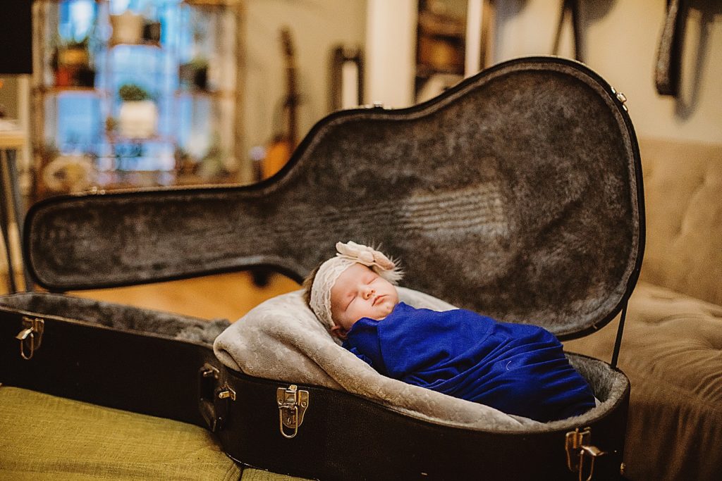 baby with guitar case
