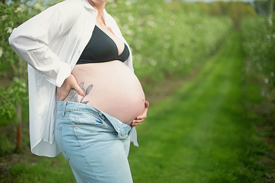 baby bump in jeans and white shirt